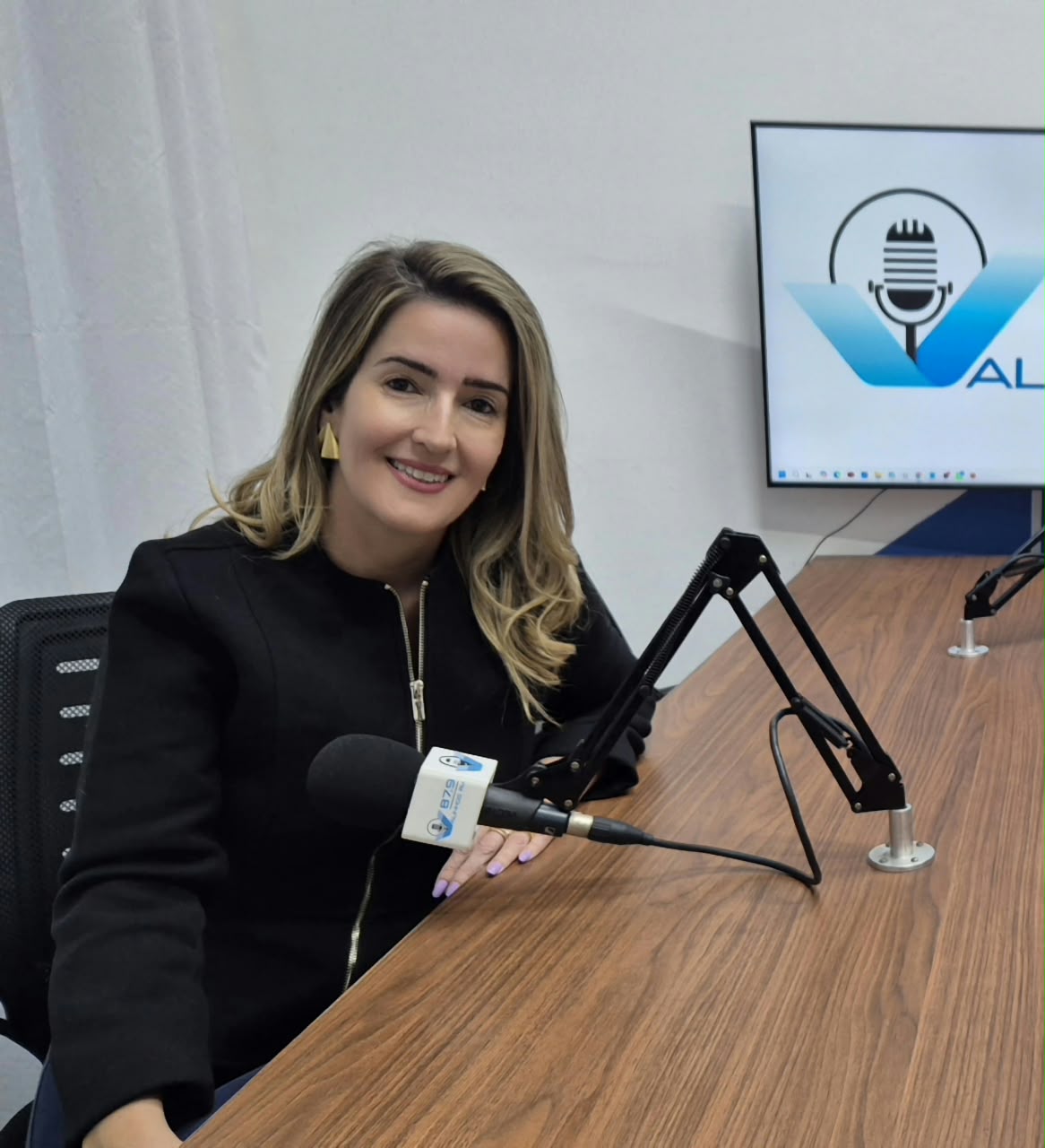 Flávia Martins durante uma entrevista em estúdio de rádio